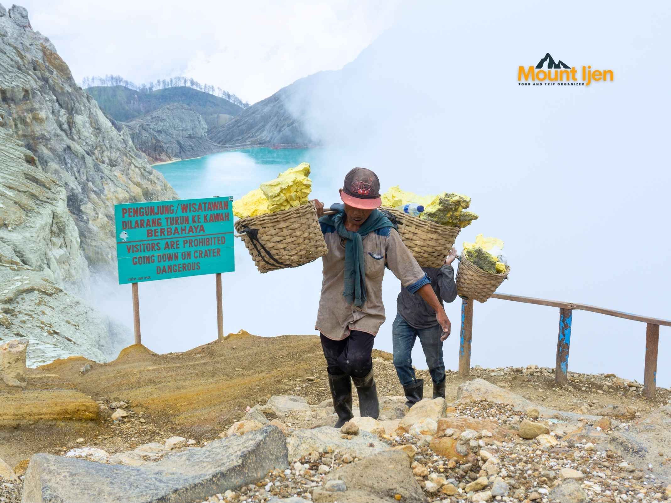 Sulfur miners carrying loads inside Kawah Ijen crater