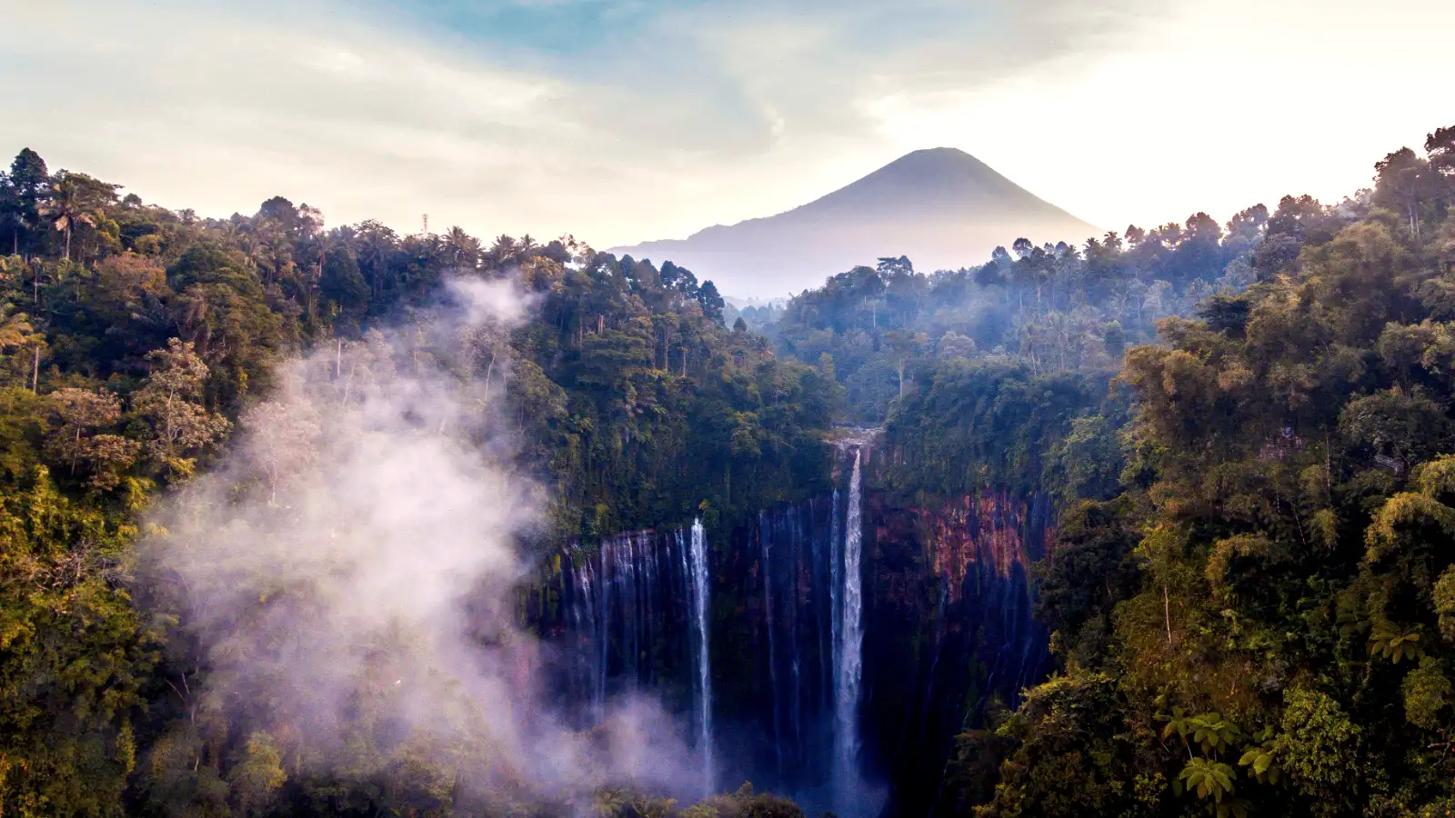 Stunning aerial view of Tumpak Sewu Waterfall with lush jungle surroundings