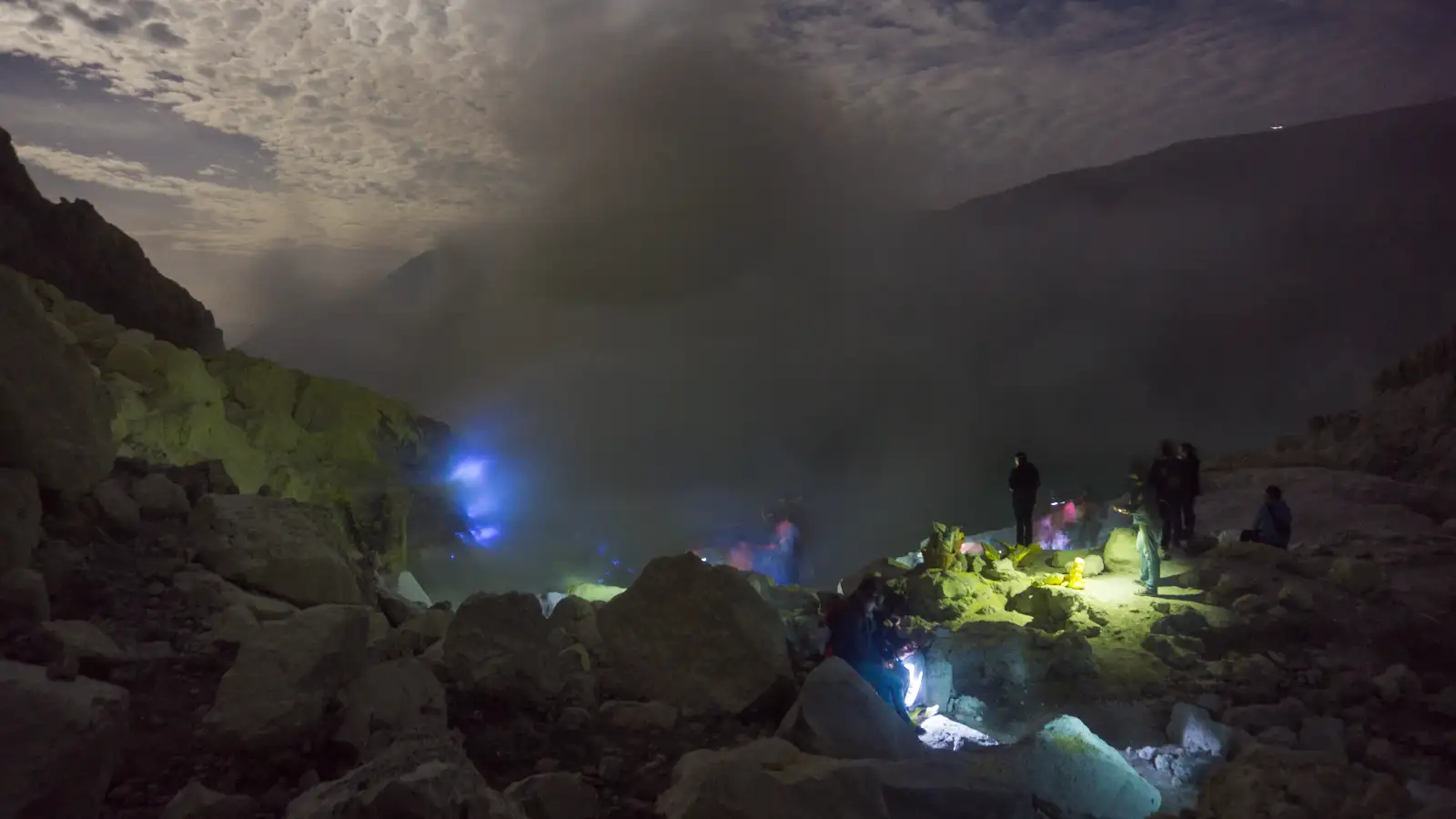 Ijen Crater Lake View Hiker looking over the Ijen turquoise acid lake