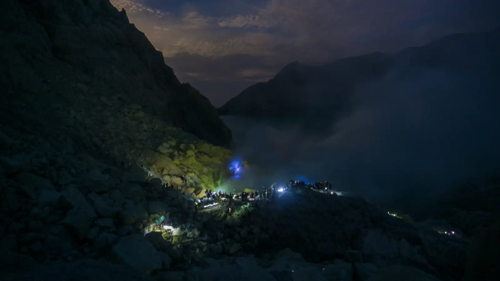 Hikers wearing gas masks near the sulfur vents of Ijen